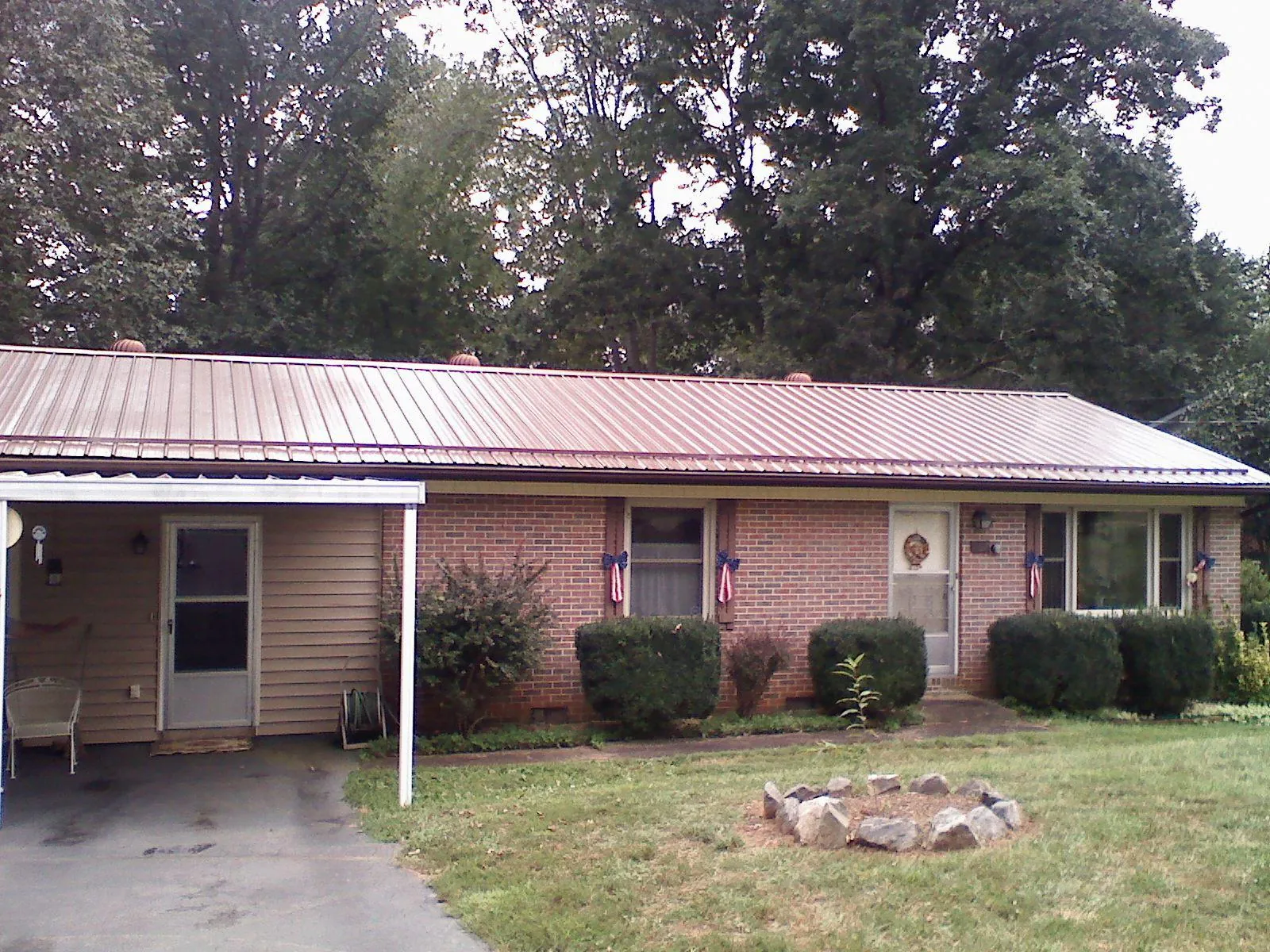 Bronze metal roof and carport on a brick ranch home — Roof Repair work by our crew in West Springfield